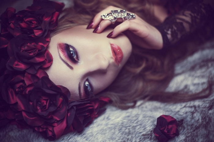 Woman with red rose wreath and blue eyes