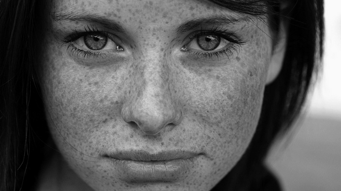 Monochrome portrait of a woman with freckles