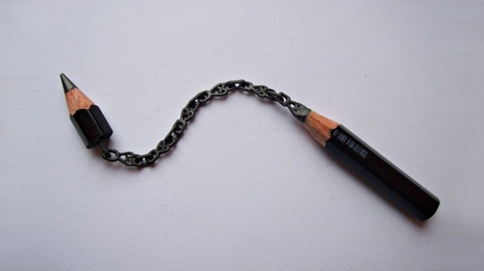 Pencil sculpture with chain on a white background