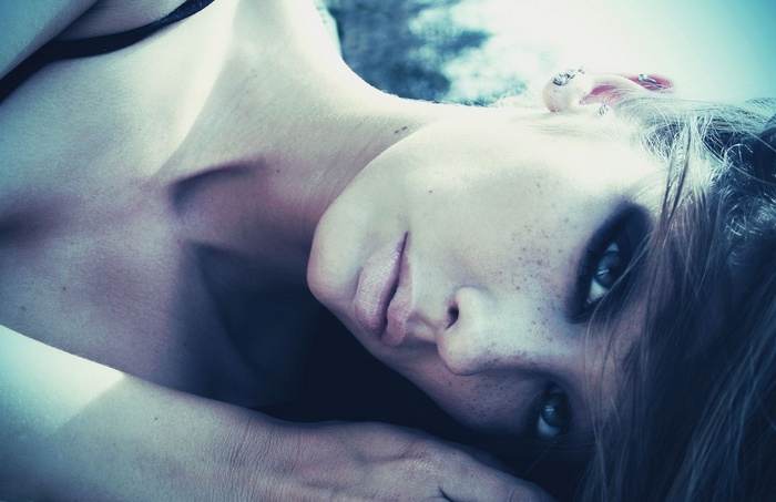 Woman with freckles and dark eyeshadow