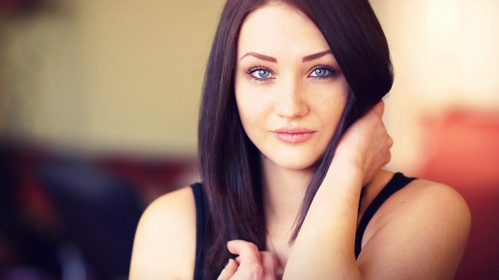 Woman with long dark hair and blue eyes