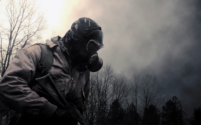Man in gas mask and military gear in a forest