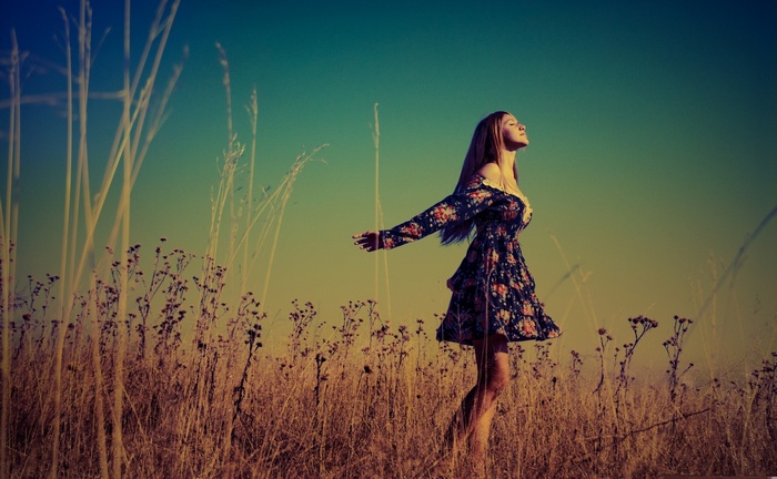 Woman in a floral dress in a field