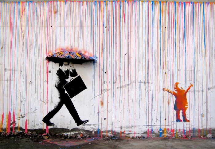 Graffiti of a businessman and a child in the rain
