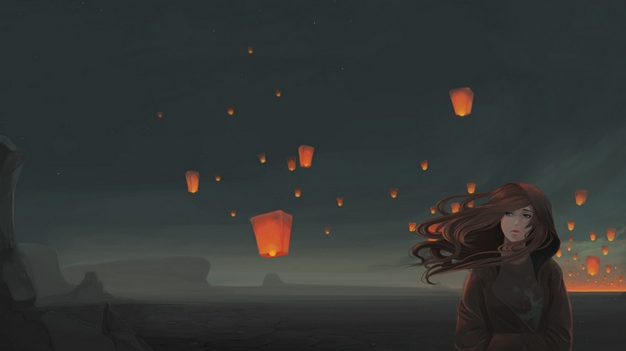 Girl in a windy night with sky lanterns