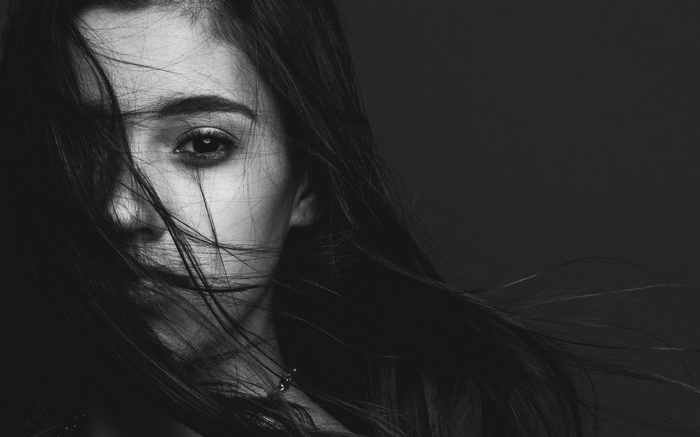 Monochrome portrait of a woman with long hair in her face