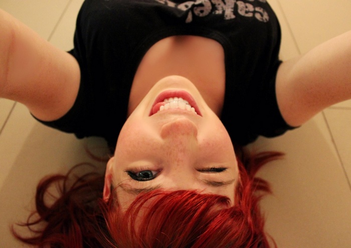 Redhead woman with freckles winking
