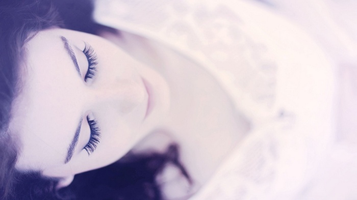 Close-up of a woman with eyes closed