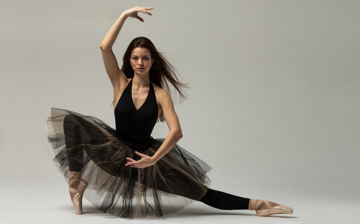 Ballerina in black tutu and pointe shoes