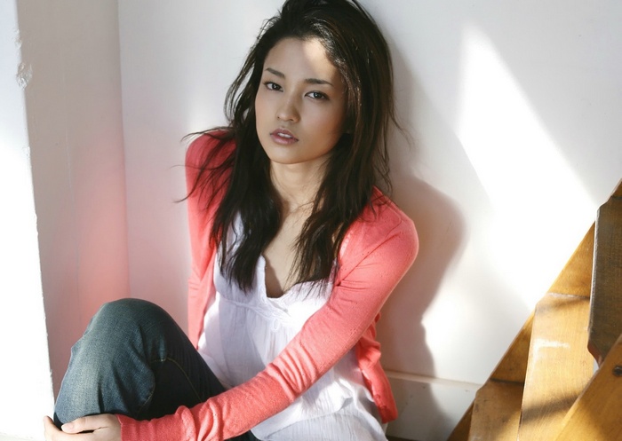 Meisa Kuroki sitting indoors