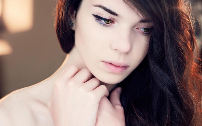 Woman with long dark hair and green eyes
