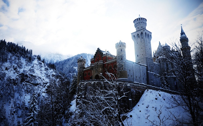 Neuschwanstein Castle in winter with snow-covered mountains