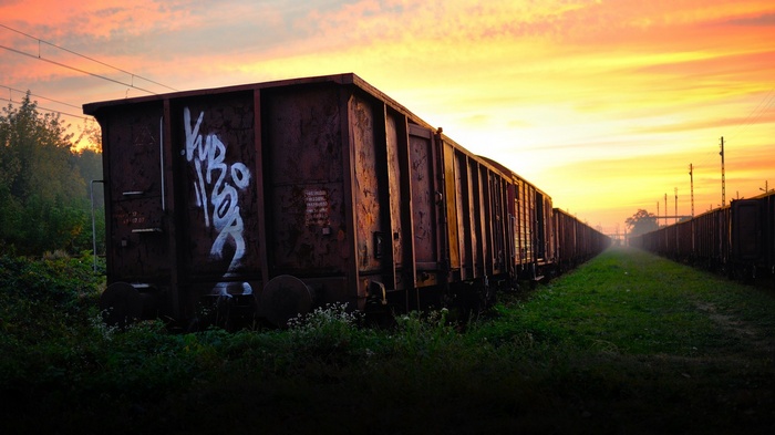 Graffiti on a train car at sunset