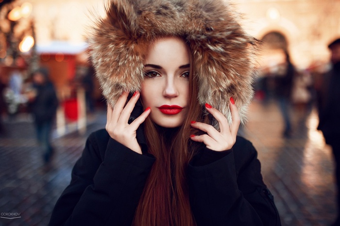 Woman with red lipstick and fur hood