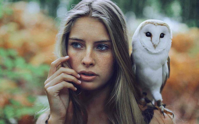 Camille Rochette with a barn owl on her shoulder