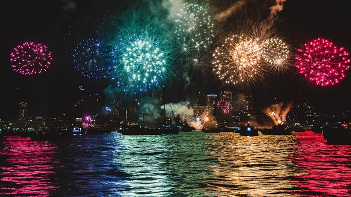 Fireworks over a city skyline at night