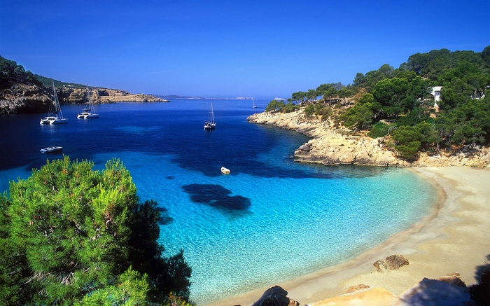 Beautiful bay with sailboats and a sandy beach in Spain