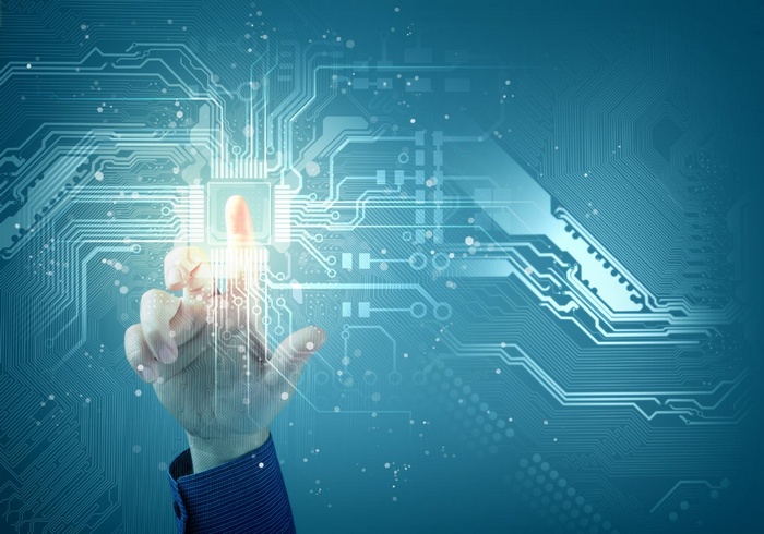 Hand touching a glowing digital circuit board