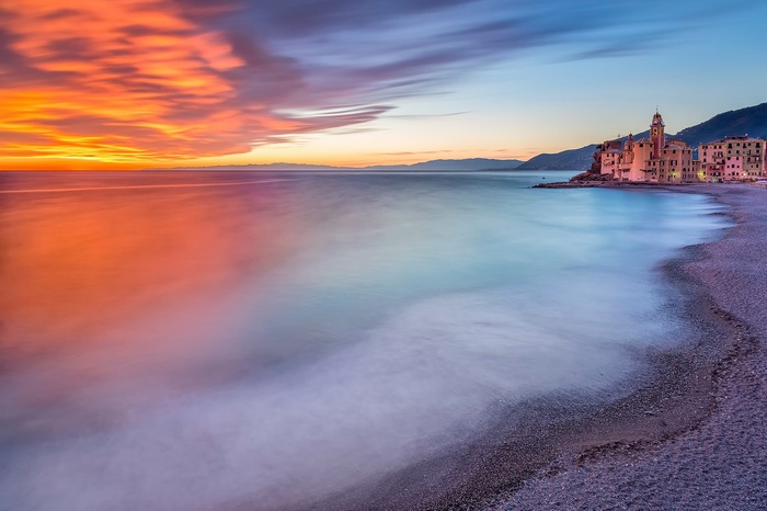 Sunset over the sea with a church in Italy