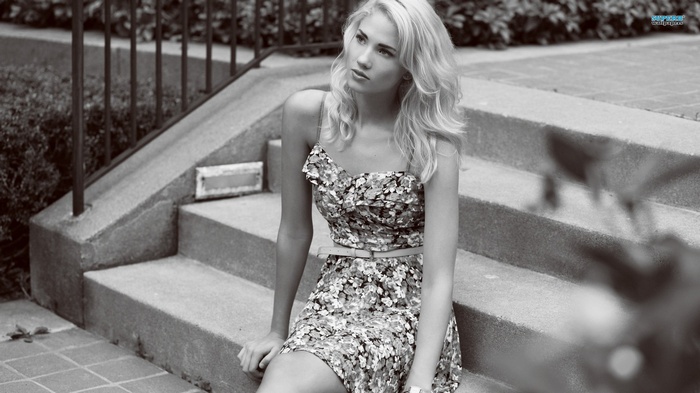 Berit Birkeland sitting on stairs in a floral dress