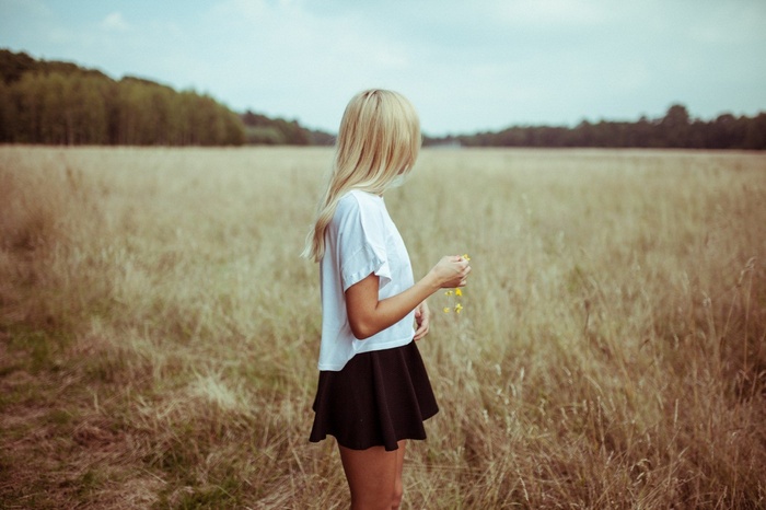 Woman with blonde hair in a field