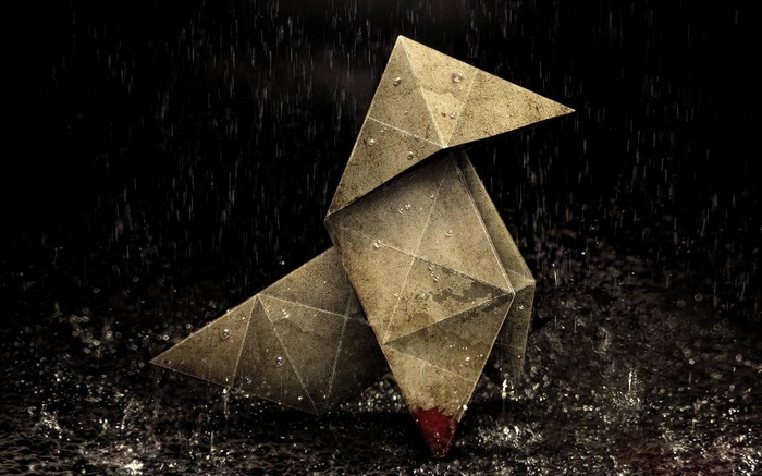 Origami bird in heavy rain