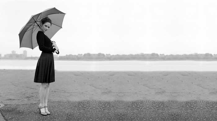 Zooey Deschanel holding an umbrella in monochrome