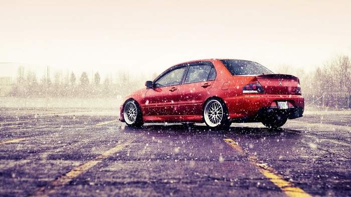 Red Mitsubishi Lancer Evo IX in Snow