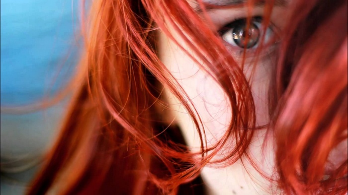 Close-up of a redhead woman with blue eyes