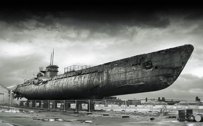 Abandoned submarine on display under a cloudy sky