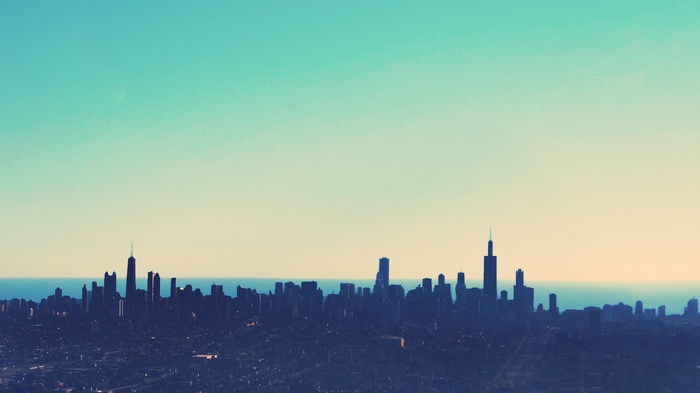 Cityscape skyline with turquoise and yellow sky