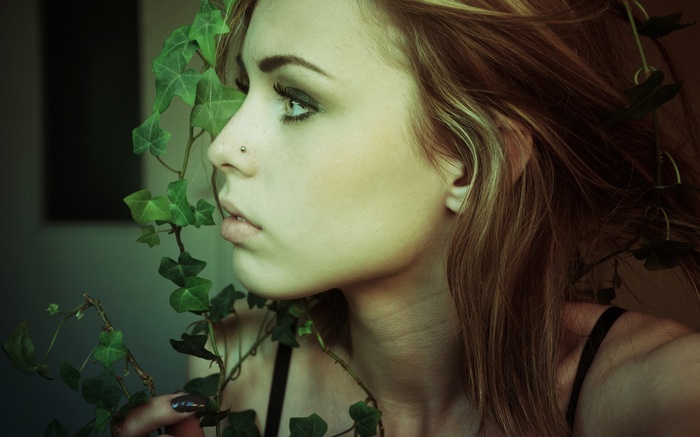 Woman with ivy in her hair and nose piercing