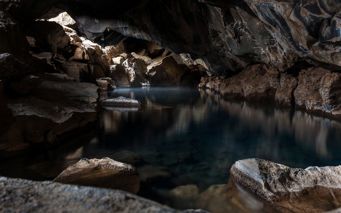 Cave with a natural pool and rock formations