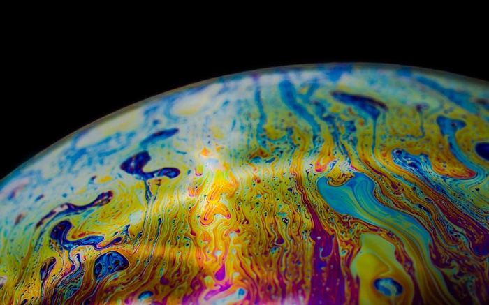 Macro photography of colorful soap bubbles on black background