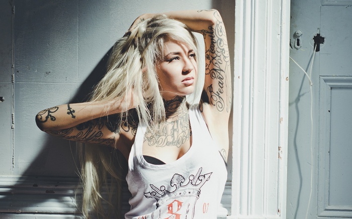 Woman with platinum blonde hair and tattoos