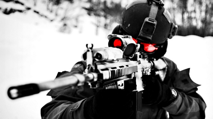 Soldier aiming an assault rifle in the snow