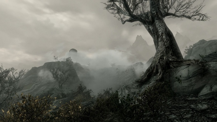 The Elder Scrolls V: Skyrim landscape with mountains and fog