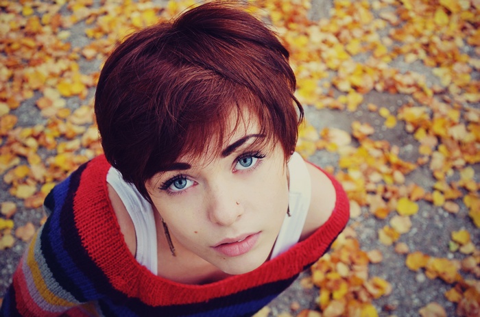 Lana Branishti with blue eyes in a sweater outdoors