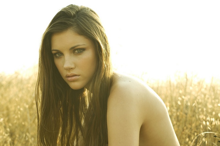 Woman with long brown hair in a field
