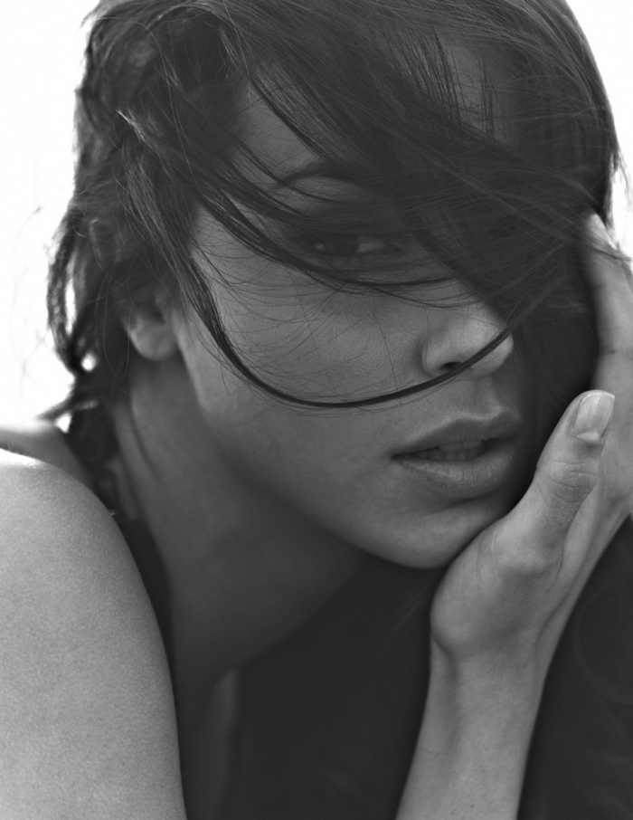 Monochrome portrait of a woman with hair in her face