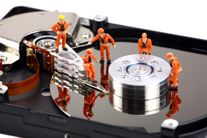 Miniature workers on a hard drive