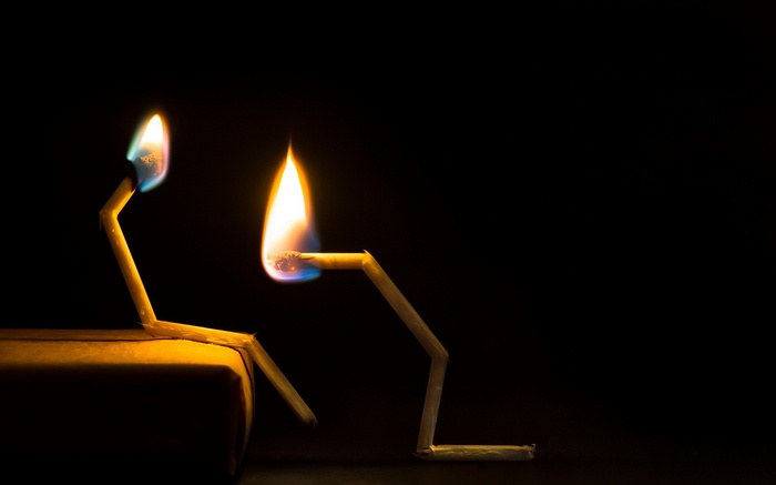 Two burning matches in the dark