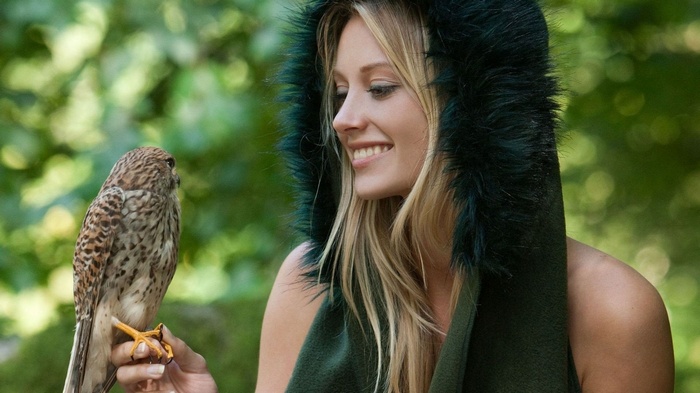 Carisha with a bird in the woods
