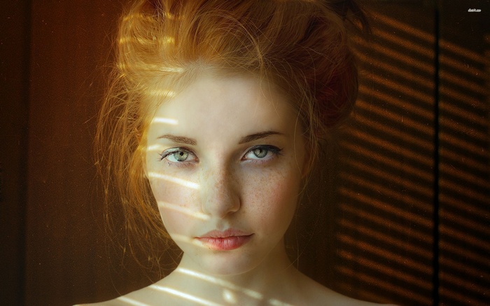 Redhead woman with green eyes and freckles
