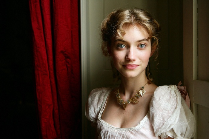 Imogen Poots in a period costume with a red curtain