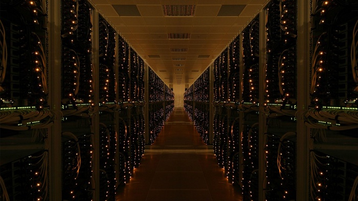 Server room hallway with rows of blinking LEDs