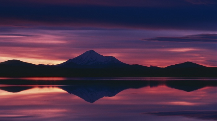 Mountain reflection at sunset over a calm lake