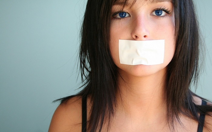 Woman with mouth taped shut