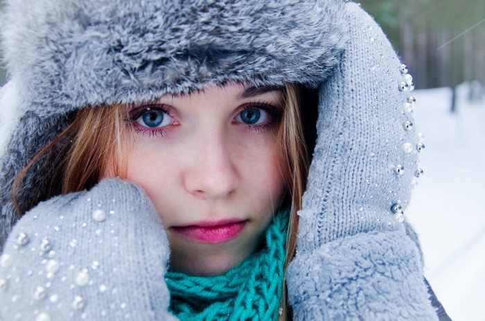 Woman with blue eyes and blonde hair in winter
