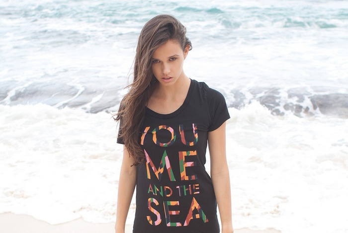 Woman wearing a T-shirt with text at the sea
